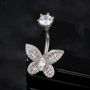 Macro detail of silver butterfly belly ring with sparkling zircon and stainless steel finish