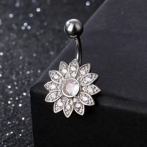 Macro shot of silver stainless steel belly ring with sparkling sunflower zircon petals