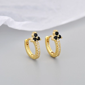 Detail of 18K gold hoop earrings with black clover zircon and pavé white stones