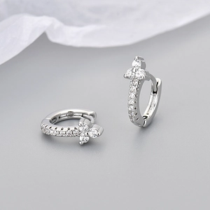 Macro shot of silver floral hoop earrings with sparkling cubic zirconia stones and S925 finish