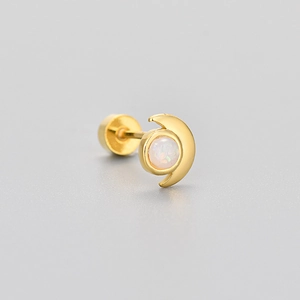 Close-up of golden moon stud earring with round white opal stone and screw back closure