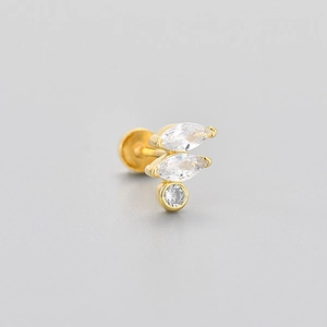 Macro detail of gold flat-back labret stud earring with marquise and round cubic zirconia