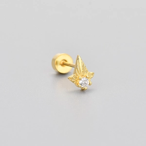 Detailed macro view of gold sunburst triangle stud earring with central round zircon