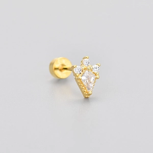 Macro shot of gold flat back earring with kite-shaped zircon and vintage beaded edge