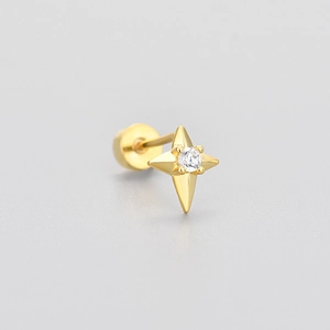 Detail of gold star screw-back stud earring with a central brilliant-cut zircon stone