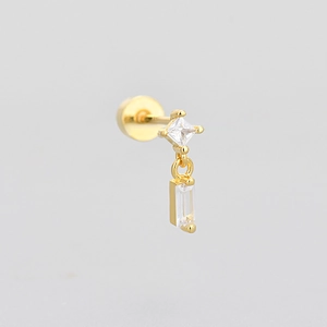 Minimalist gold earring with square and rectangle cubic zirconia drops on grey background