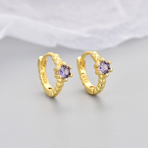 Detail of S925 hallmark on gold plated hoop earrings with purple zircon gemstone