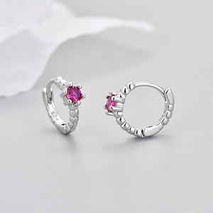 Detail of 925 sterling silver hoop earrings with round pink zircon and engraved purity mark