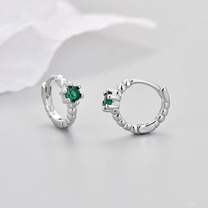 Macro view of S925 silver hoop earring with green zircon and clear 925 hallmark