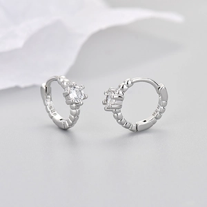 Polished silver textured hoop earrings with sparkling cubic zirconia solitaire stones