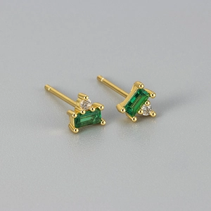 Macro shot of rectangular emerald green zircon stud earrings with gold plating finish