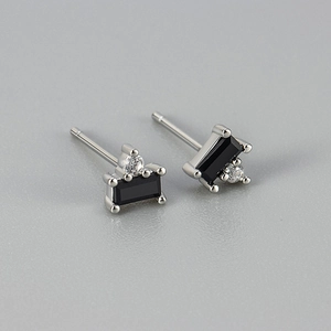 Detail of silver stud earrings featuring rectangular black gemstone and zircon accents