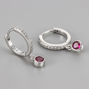 Close-up of S925 sterling silver hoop earrings with white zircon and ruby-red pendants