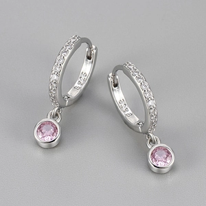 Close-up of S925 hallmark on silver hoop earrings with pink round zircon pendant