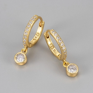 Close-up of S925 sterling silver hoop earrings with pavé zircons and round pendants