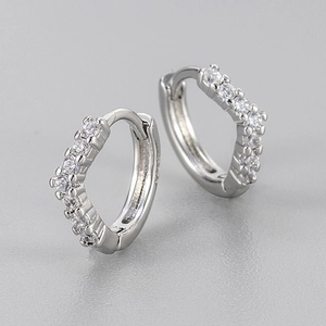 Macro shot of V-shaped silver earrings with S925 hallmark and sparkling cubic zirconia