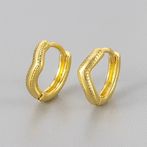 Macro shot of S925 sterling silver stamp on irregular gold plated hoop earrings