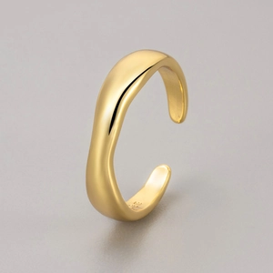 Detailed macro view of S925 engraved stamp on minimalist golden wave pattern open ring