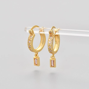 Golden hoop earrings with pink rectangular zircon pendant and star engravings
