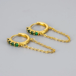 Detail of 18K gold hoop earrings with green cubic zirconia and delicate chain fringe
