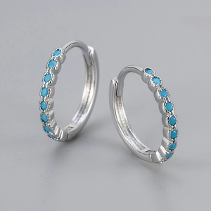 Elegant silver hoop earrings with a row of blue turquoise stones for a minimalist look