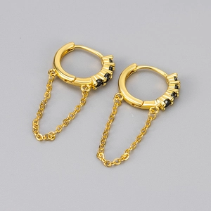 Detail of 18K gold-plated hoop earrings with black zircon stones and a delicate link chain