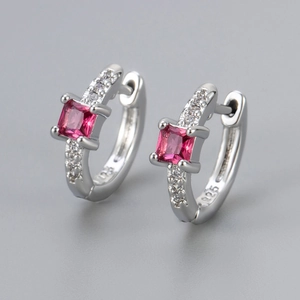 Macro shot of S925 sterling silver huggie earrings with pink square zircon and micro-inlay