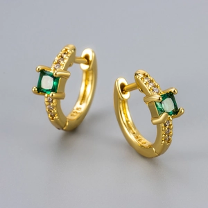 Detail view of 925 silver stamp and emerald zircon setting on gold earrings