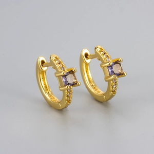 Macro detail of gold S925 silver hoop earrings with square purple zircon and small white diamonds