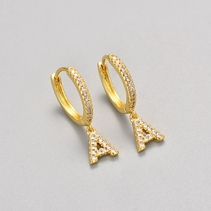 Detail of gold letter A earring charm with micro-paved white cubic zirconia stones