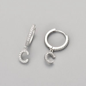 Close-up of S925 silver hoop earrings with letter C pendant and cubic zirconia