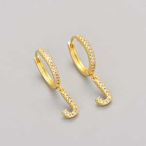 Detail of gold letter J hoop earrings featuring pave-set white cubic zirconia stones