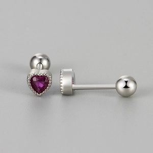 Detailed macro view of heart-shaped silver ear studs with purple zircon and screw back