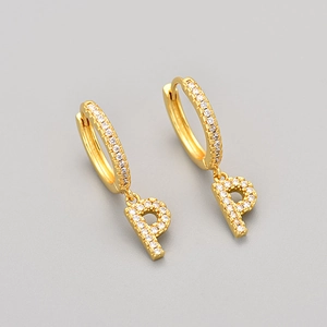 Detailed close-up of golden letter P hoop earrings with sparkling white cubic zirconia