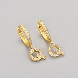 Close-up of gold letter Q hoop earring with white pave-set cubic zirconia stones