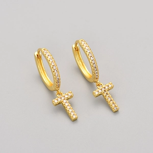 Detail of gold-plated T-letter drop earrings with shimmering micro-paved white zircons