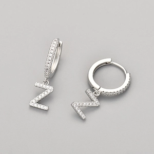 Macro shot of silver-tone letter Z hoop earrings with micro-paved white zircons