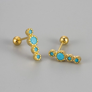 Macro shot of S925 silver gold-plated stud earrings with green turquoise stones