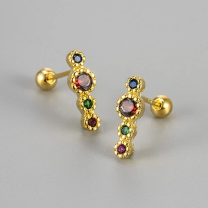 Macro view of S925 silver gold-plated stud earrings with four colorful gradient crystals