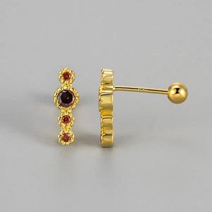 Detail of gold-plated S925 silver stud earring with four round orange zircons and screw back