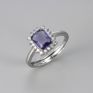 Macro detail of rectangle purple gemstone ring with sparkling white zircon halo accents