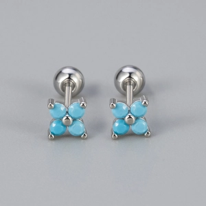 Detail of clover earrings with turquoise beads and screw-back closure in silver finish
