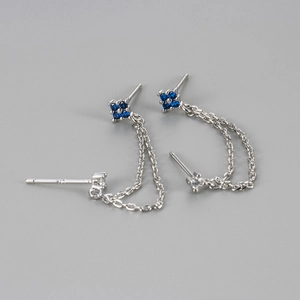 Macro shot of S925 sterling silver chain earrings with blue clover zircon for double piercing
