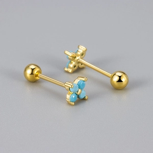 Close-up of gold four-leaf flower studs with turquoise stones and screw ball back