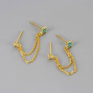 Detail of 925 sterling silver chain earrings with white zircon and blue beads