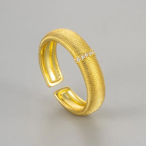 Vintage style gold brushed ring with silk texture and four white cubic zirconia stones