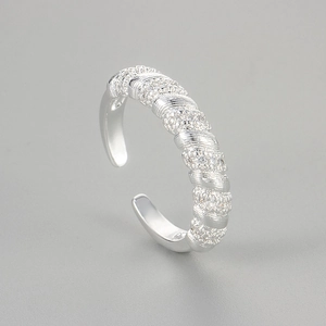 Macro shot of twisted silver ring band with pave set white cubic zirconia stones