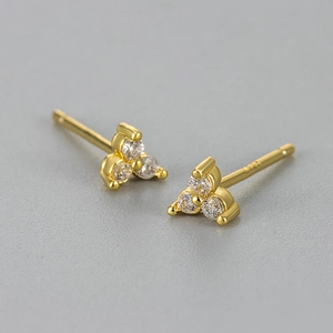 Macro shot of gold-plated S925 silver stud earrings with three-prong zircon clover design