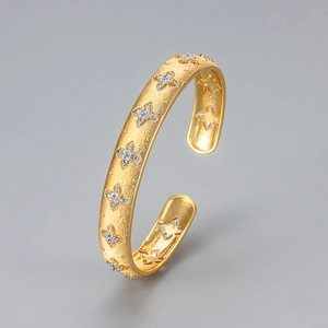 Italian style brushed gold cuff bracelet with star cutouts and sparkling zircon stones