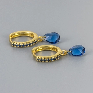 Detail of S925 stamped gold hoop earring with teardrop blue zircon and micro-pave setting